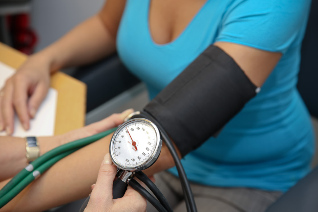 doctor with stethoscope patient attaches the blood pressure
